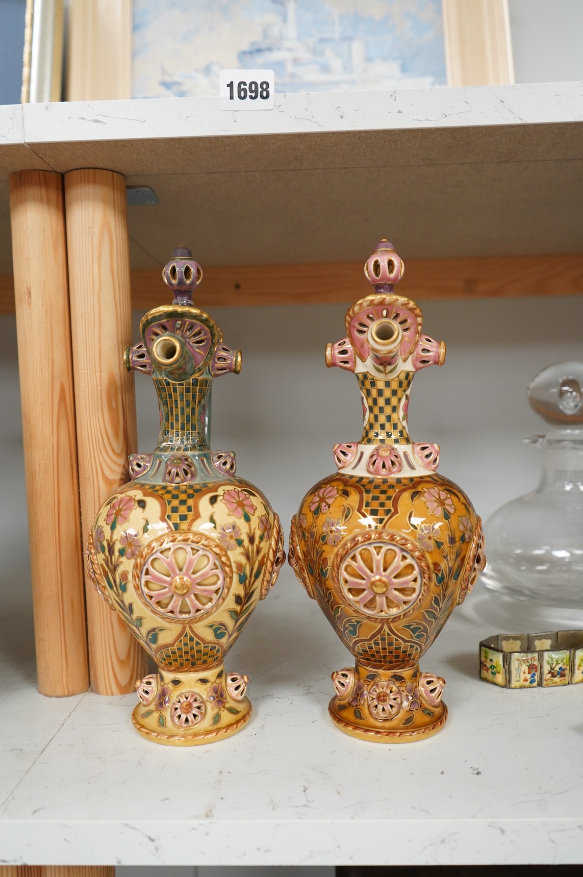 Two Zsolnay Persian inspired jugs / ewers and covers, stamped to the bases 29cm high